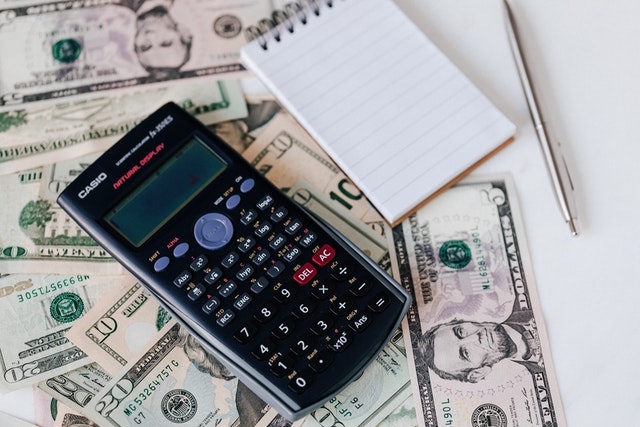 a%20calculator%20and%20notebook%20on%20cash